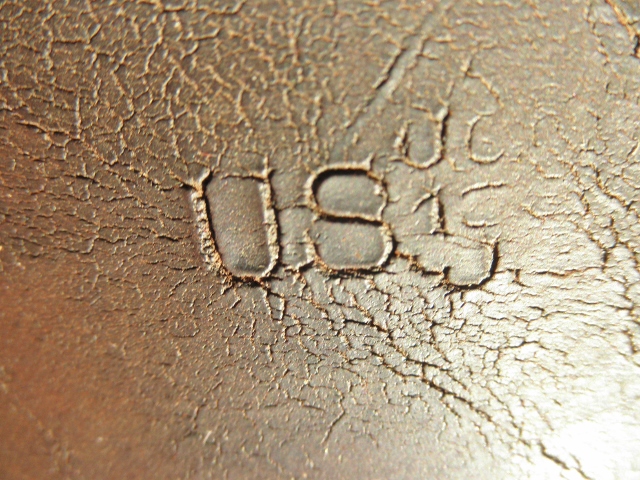 'US' Stamp close-up w/unidentified letters/numbers