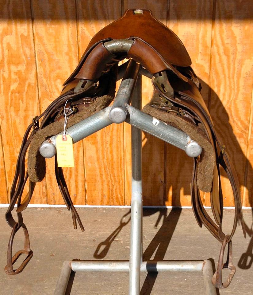 This is front view through the arches. Note how flat the sidebars are in this photo as they are flexed out by saddles weigh on their outside edge as sitting on stand. compare with same saddles' rear view on narrower stand where sidebars are sitting on inside edges.
