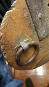 Small fragment of rawhide show where narrowed shanks of staple set on cover.